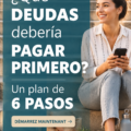 Femme souriante consultant un plan de remboursement de dettes sur une table.